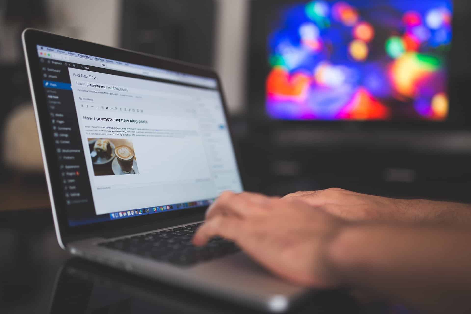 A laptop opened to the “post” section on wordpress where someone is writing a blog in the test box.